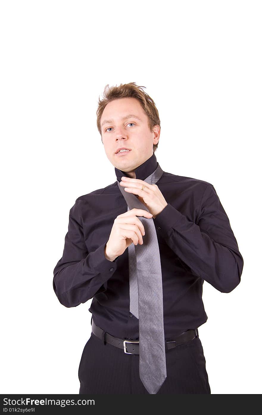 Businessman putting on a tie