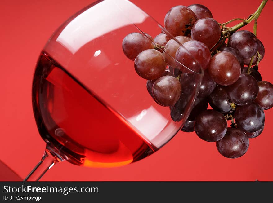 A glass of wine with grapes