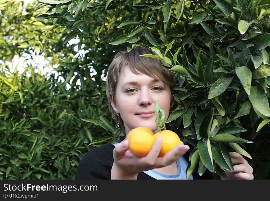 Portrait of woman with orange in a orchard. Portrait of woman with orange in a orchard