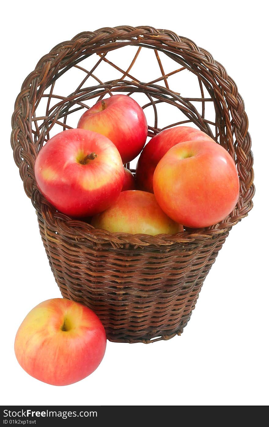 Old vintage wicker basket with red apples. Isolated on a white background.