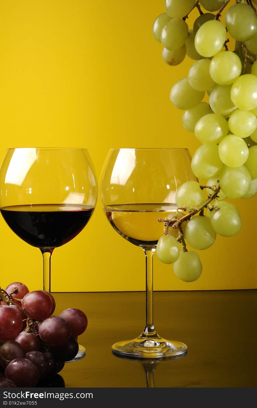 Two glasses of wine with grapes