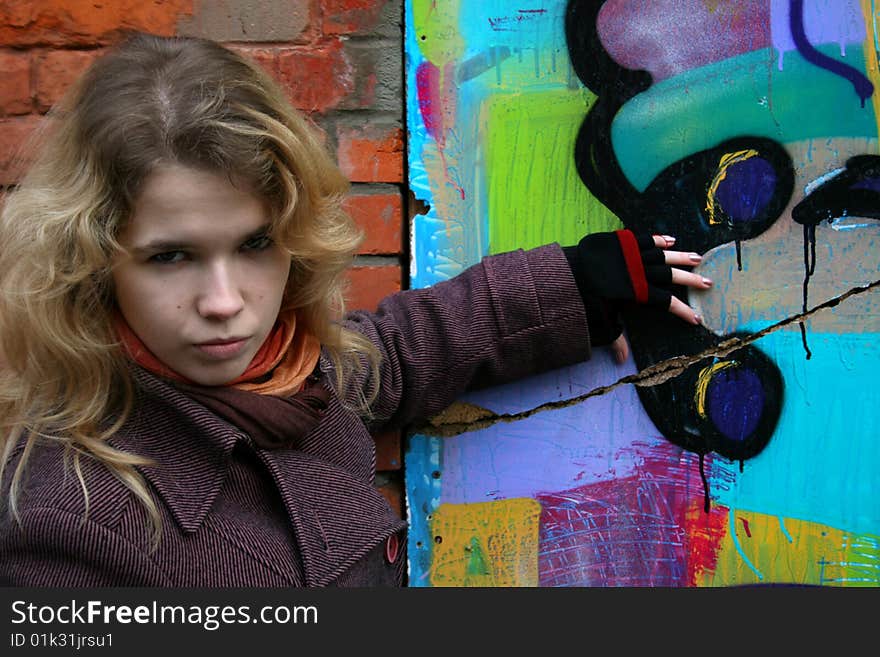 Girl standing near graffiti outdoor