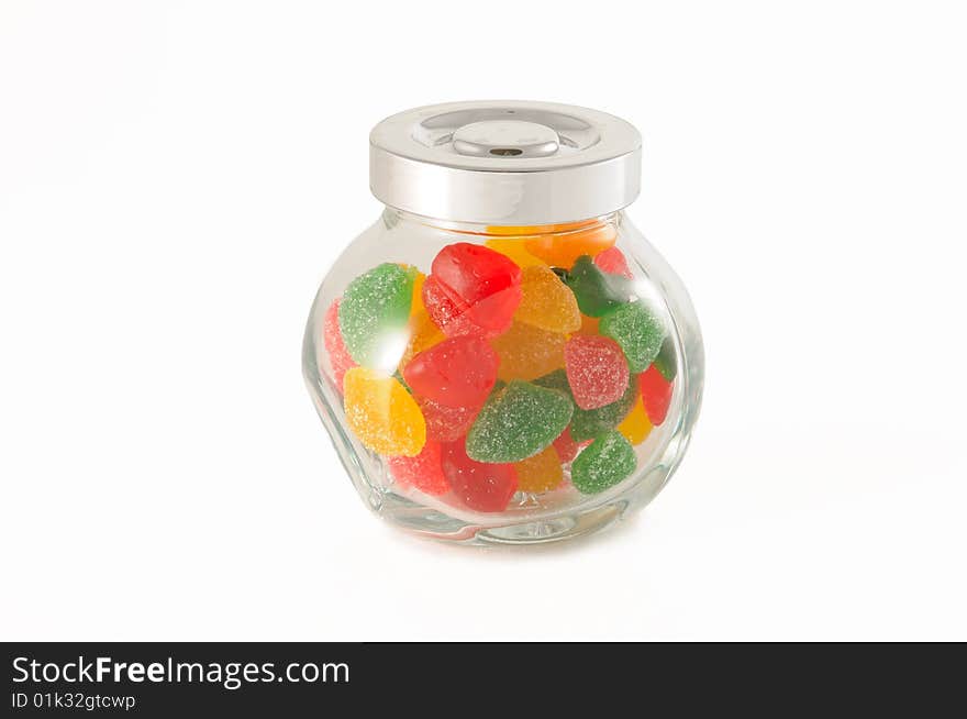 Fruit jellys in glass phial on white background