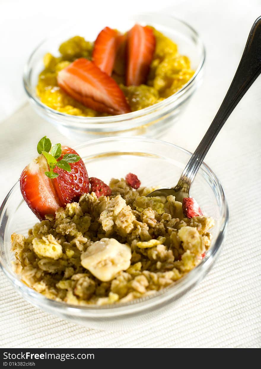 Cornflakes and musli with strawberry on a white cover. Cornflakes and musli with strawberry on a white cover