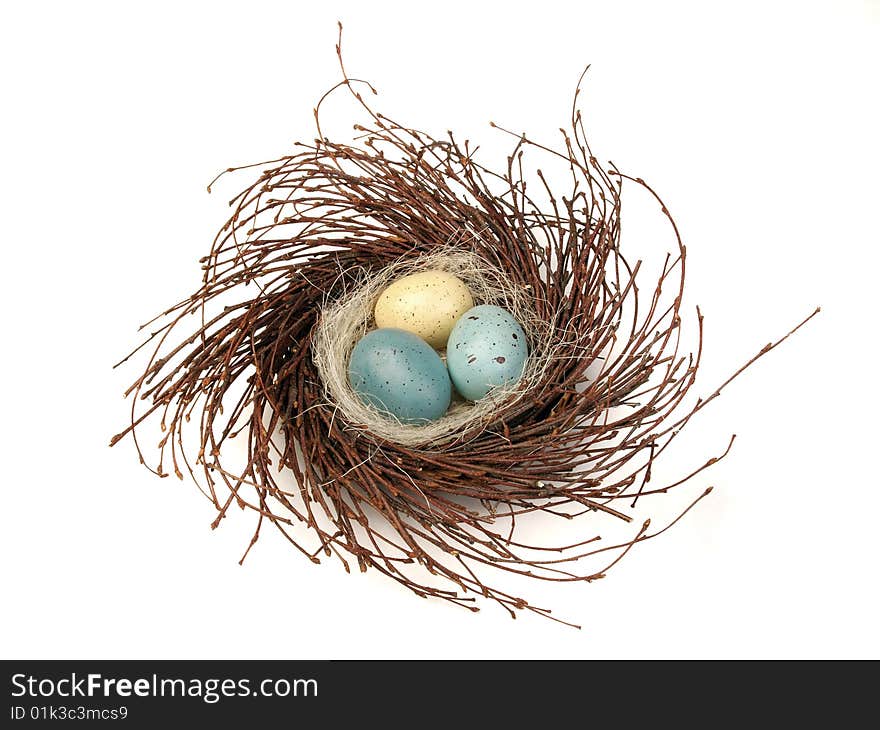 Painted eggs in bird's nest isolated on white background. Painted eggs in bird's nest isolated on white background