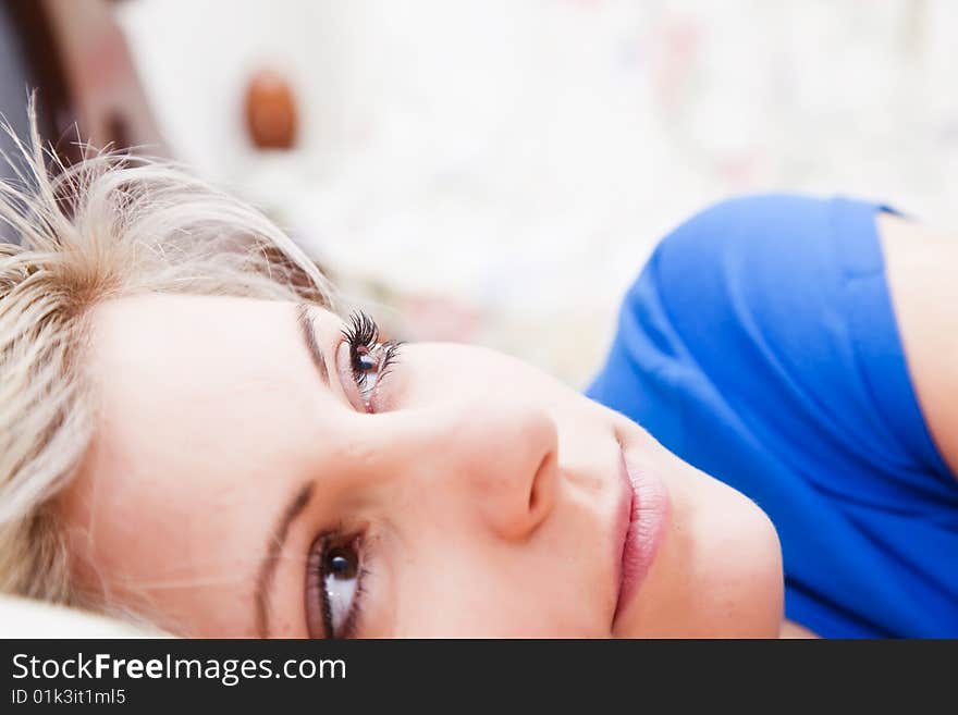 Pensive woman portrait still in bed.