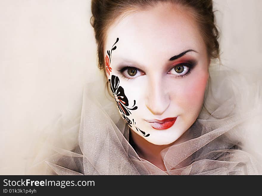 Girl with black flower on her white face. Girl with black flower on her white face