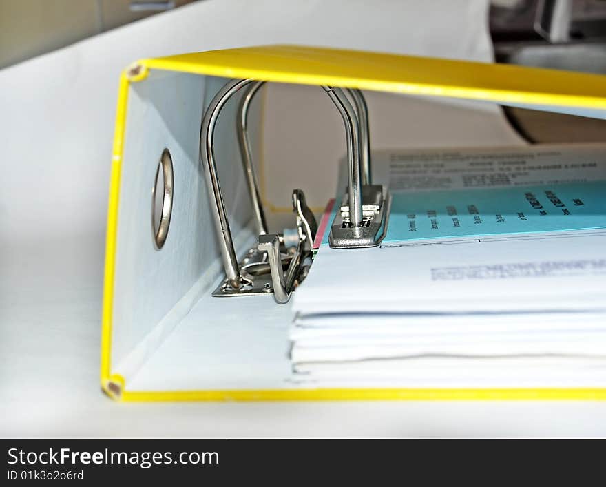 Documents in paper file with metallic lock mechanism. Documents in paper file with metallic lock mechanism