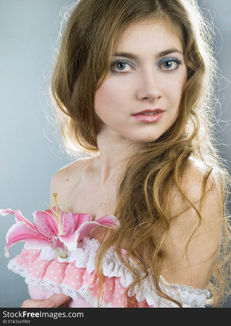 Beautiful young girl with lily flower