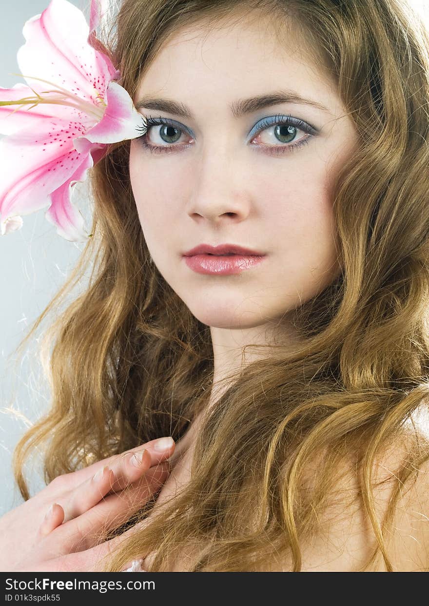 Beautiful young girl with lily flower