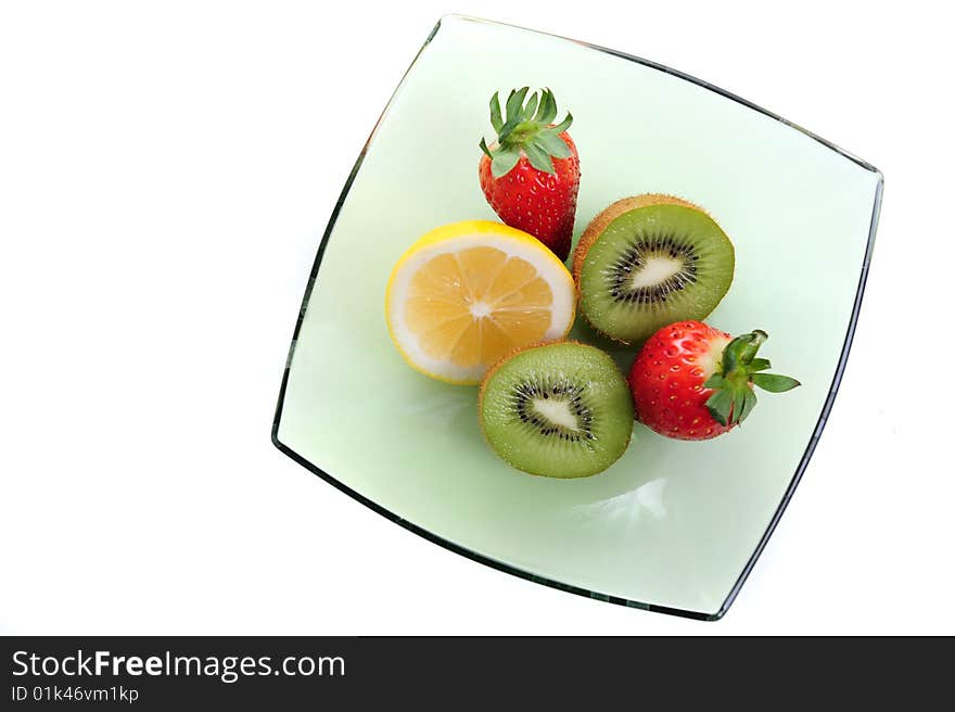 Kiwi, strawberry and lime on green bowl. Kiwi, strawberry and lime on green bowl