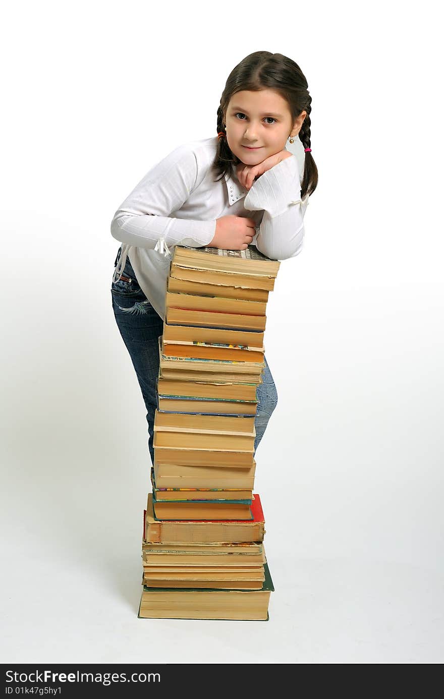 Young girl and a stack of books. Young girl and a stack of books