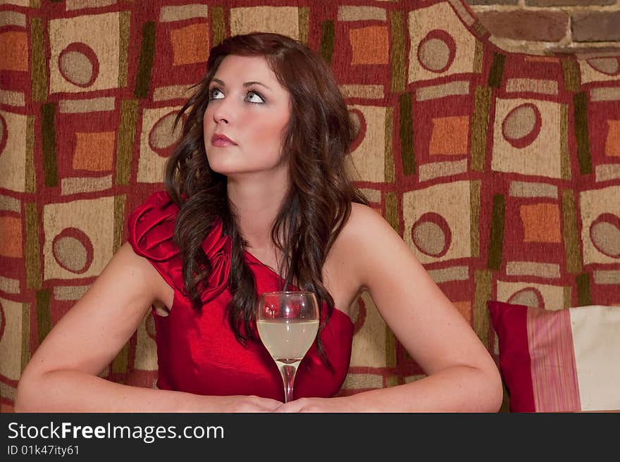 Woman waiting at the bar with a drink