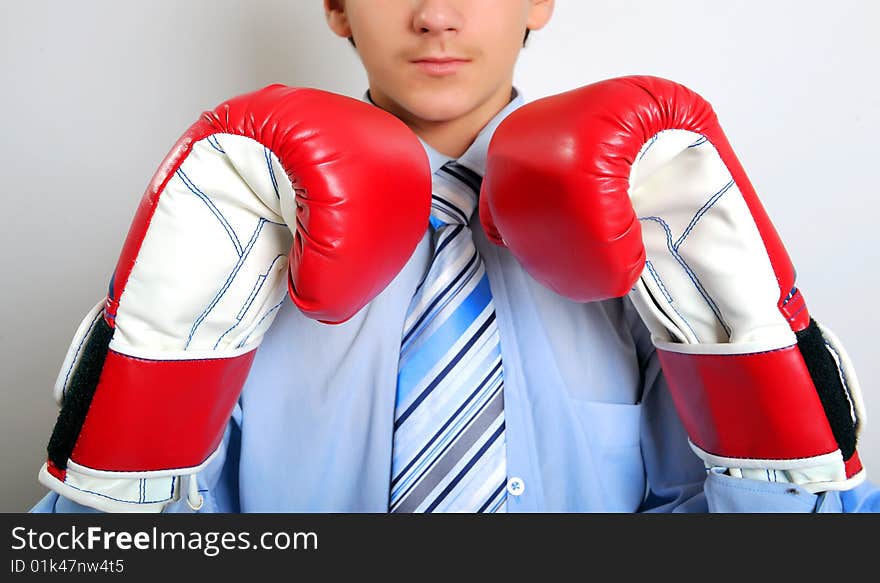 Young businessman wearing boxing gloves. Young businessman wearing boxing gloves