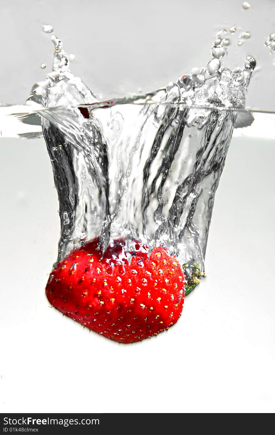 Strawberry falling in water, close up. Strawberry falling in water, close up