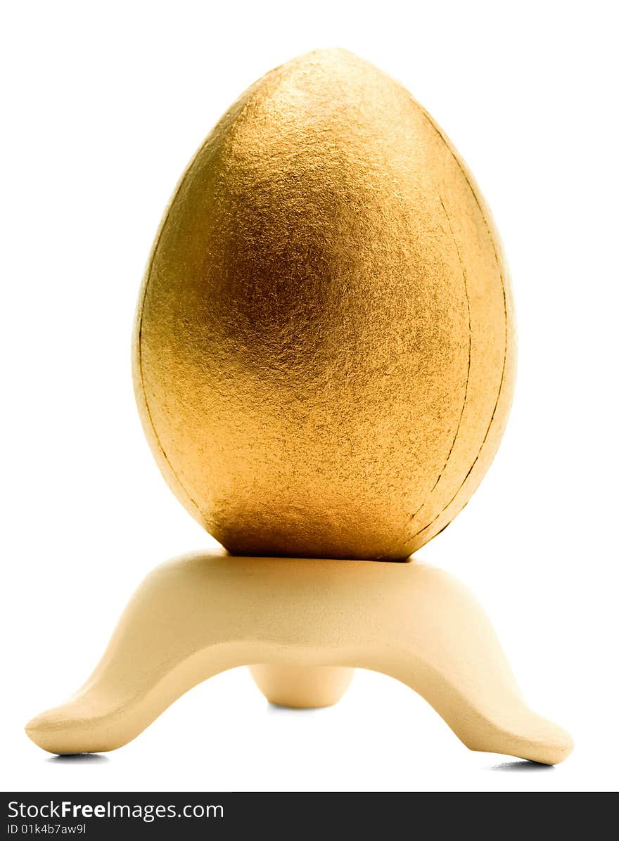 One golden egg on a stand isolated over white