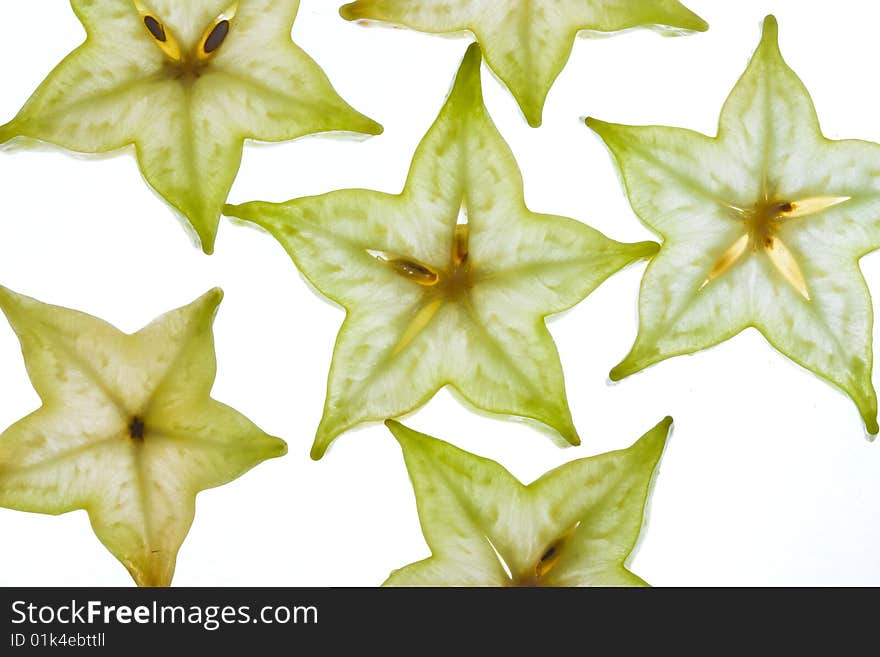 Fruit background: sliced carambola on the white