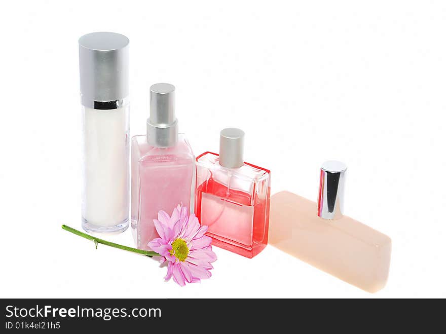 Some perfume bottles with pink flower isolated on white. Some perfume bottles with pink flower isolated on white.