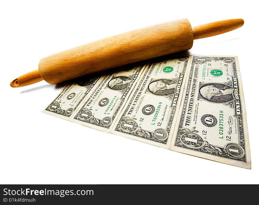 Rolling pin on us paper currency isolated over white. Rolling pin on us paper currency isolated over white