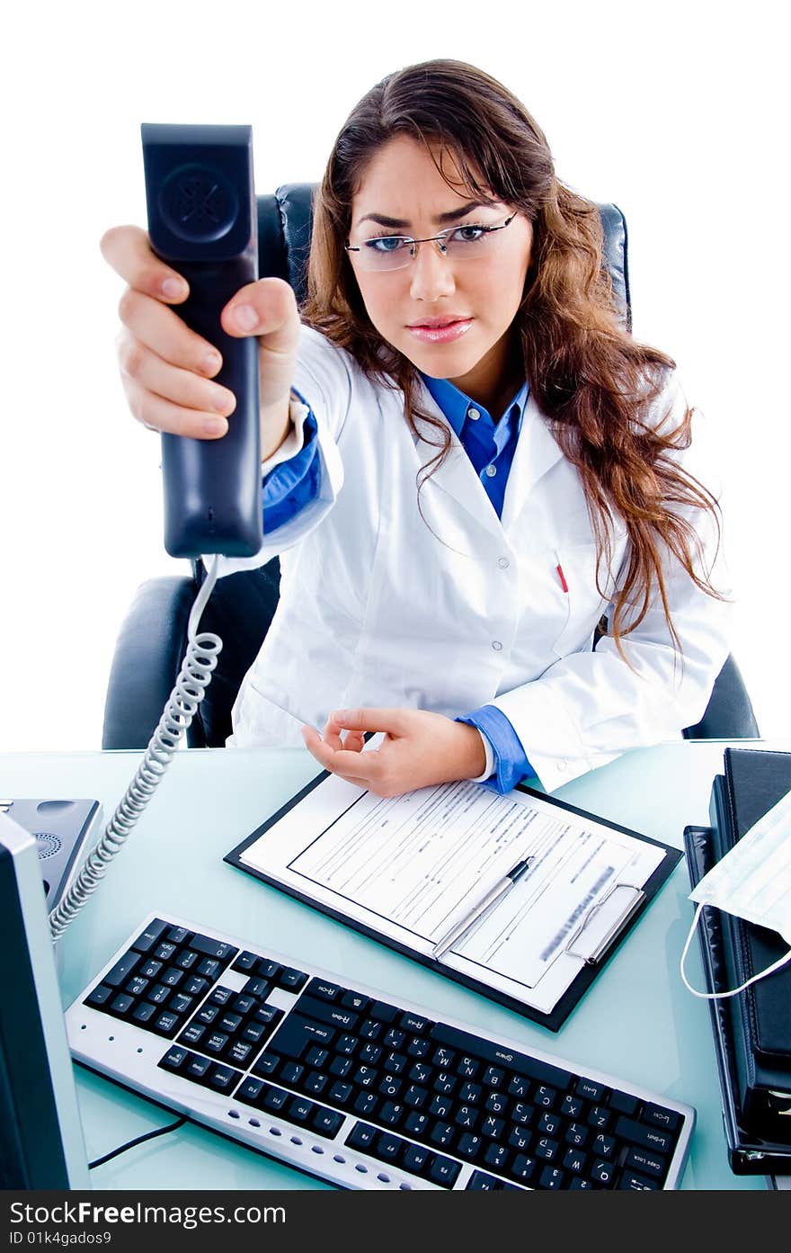 Young female doctor showing phone receiver on an isolated background