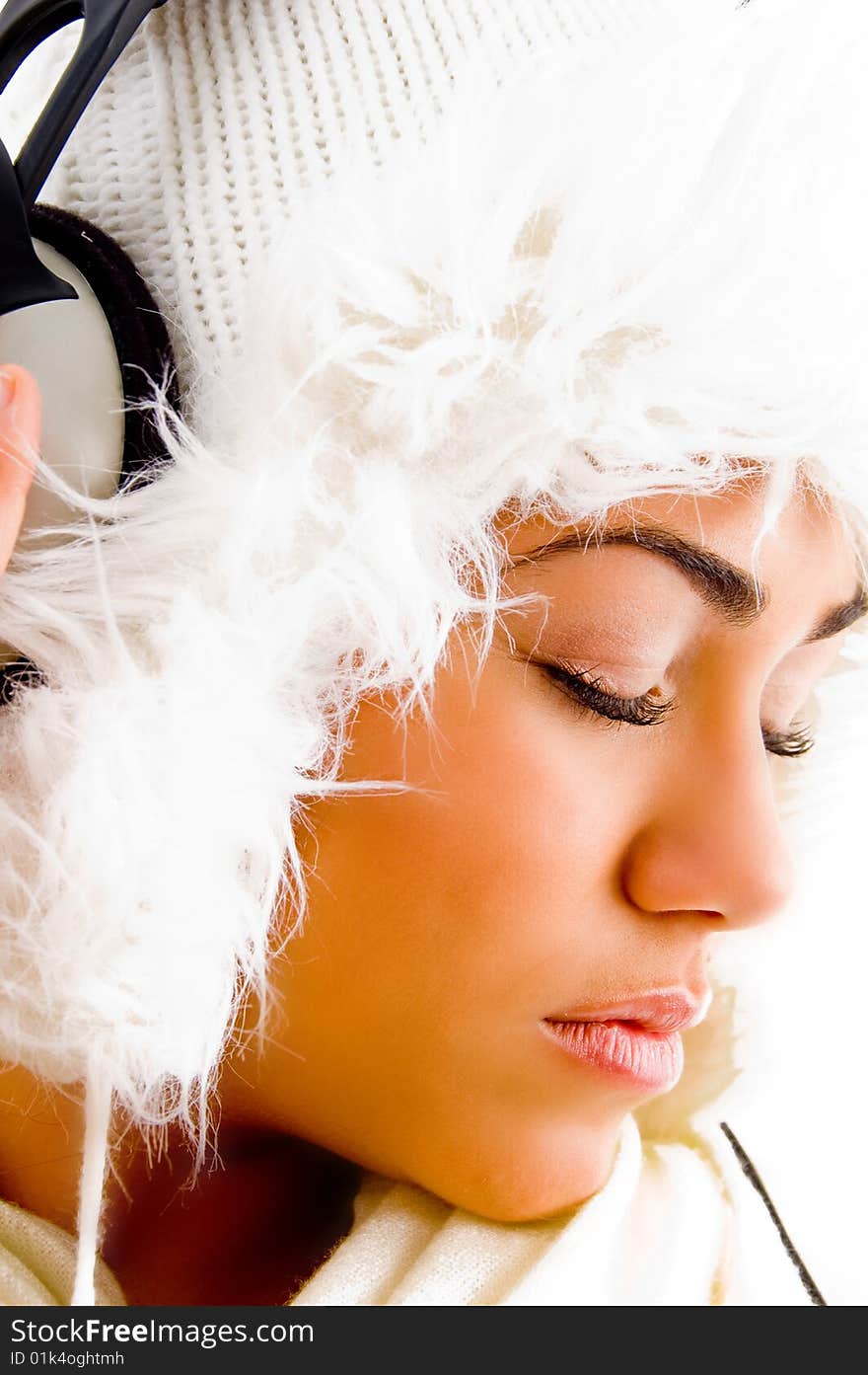 Young girl listening light music with closed eyes on an isolated background