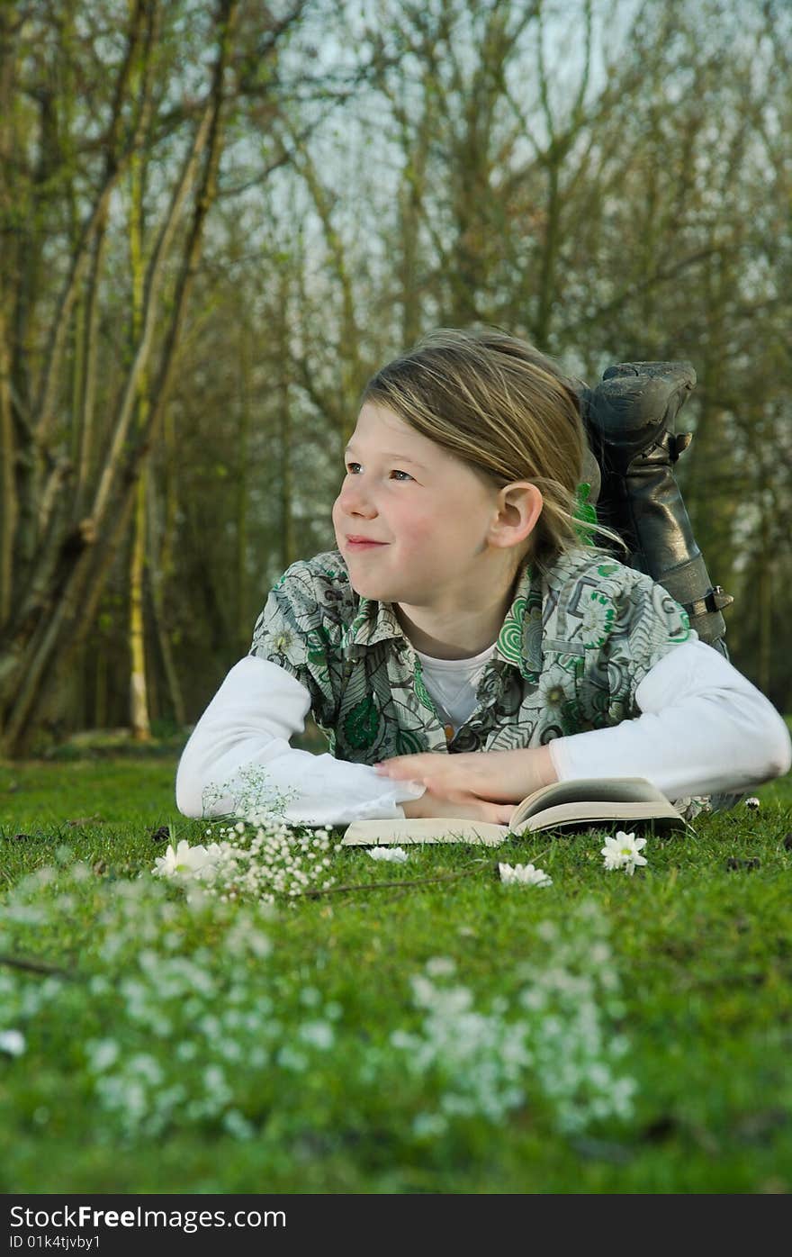 Girl Reading Book On Grass