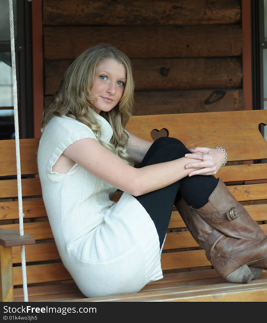 Attractive bond teen on porch swing. Attractive bond teen on porch swing