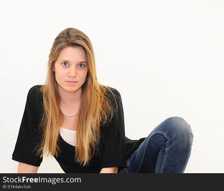 Attractive red head girl on white background in jeans and black shirt. Attractive red head girl on white background in jeans and black shirt