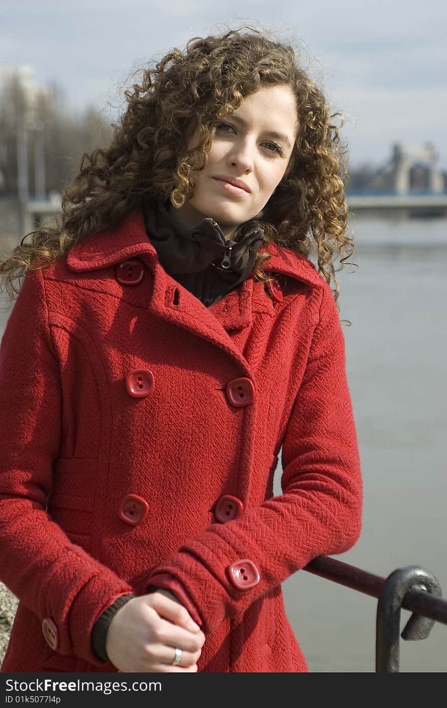 Teenage girl in Poland, portrait. Young girl with curly hairs wearing red coat, posing in Wroclaw city. Teenage girl in Poland, portrait. Young girl with curly hairs wearing red coat, posing in Wroclaw city.