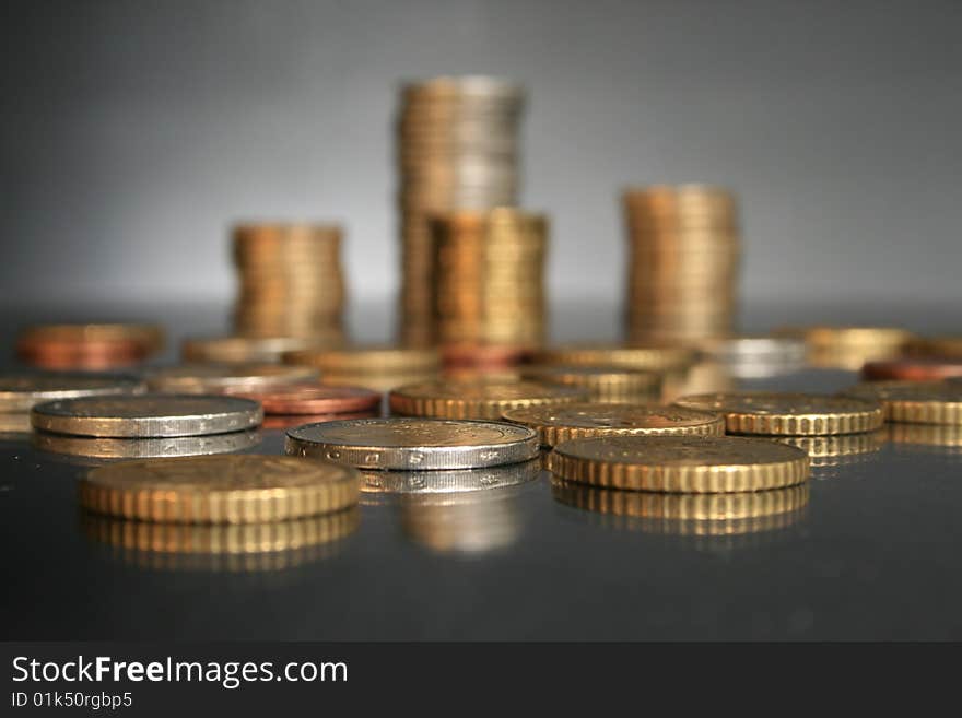 Coins on a glass table. Financial concept.