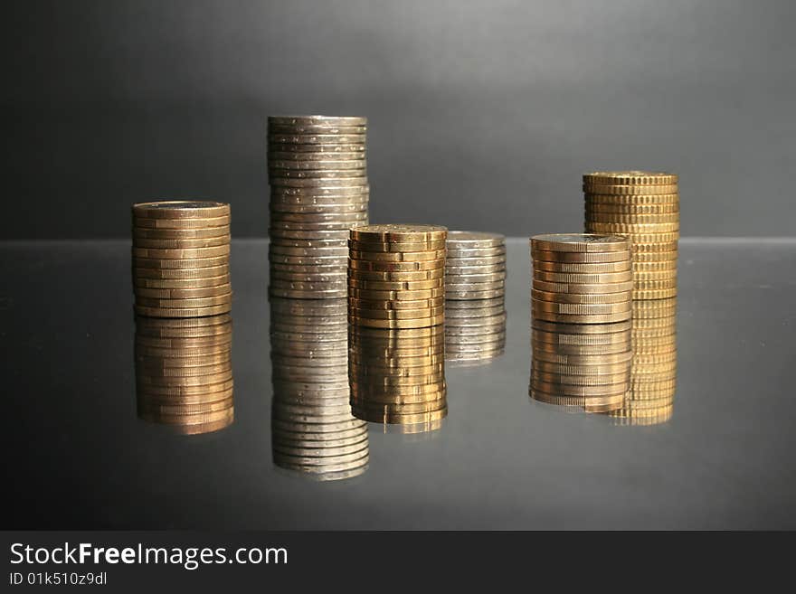 Coins on a glass table. Financial concept.