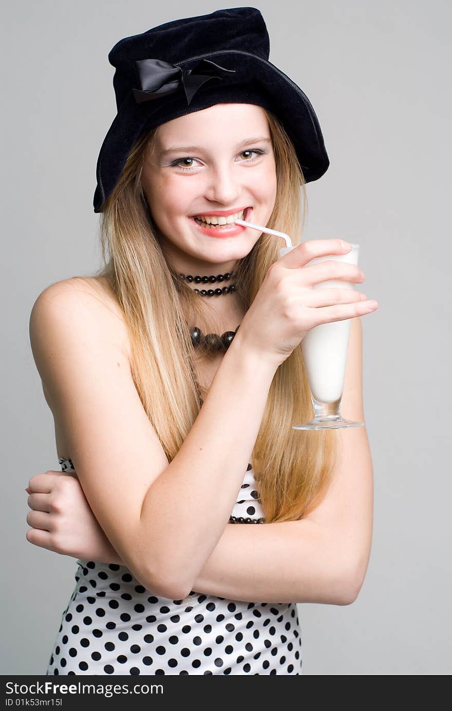 Laughing girl with a glass of milk cocktail portrait. Laughing girl with a glass of milk cocktail portrait