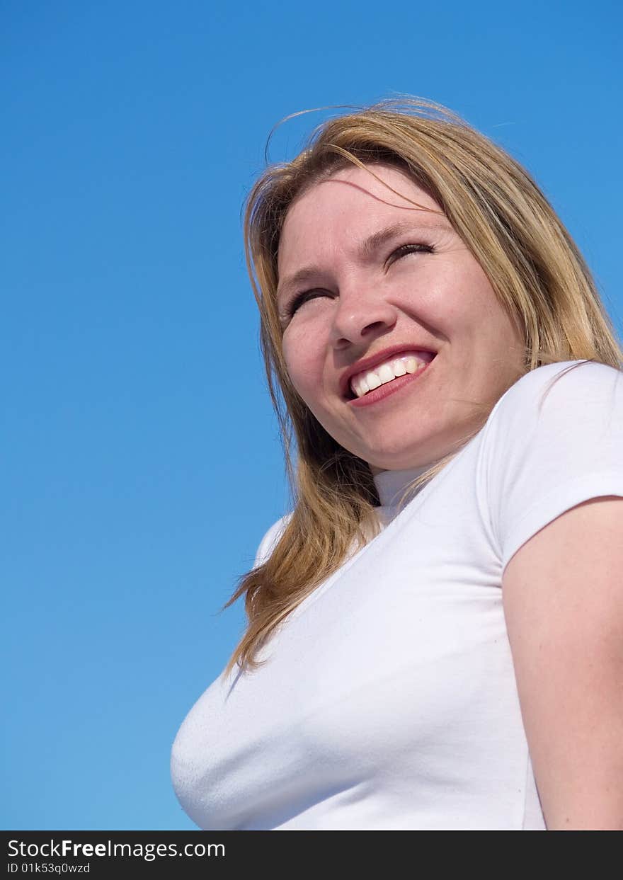 Woman in white on background of the sky