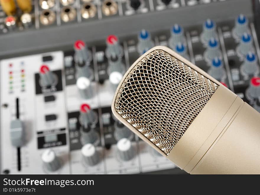 Studio microphone on the audio control console background