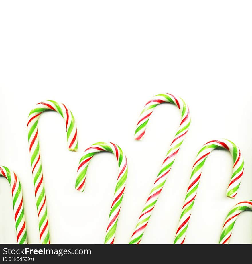 Four red and green Christmas candy canes isolated on white (real photo)