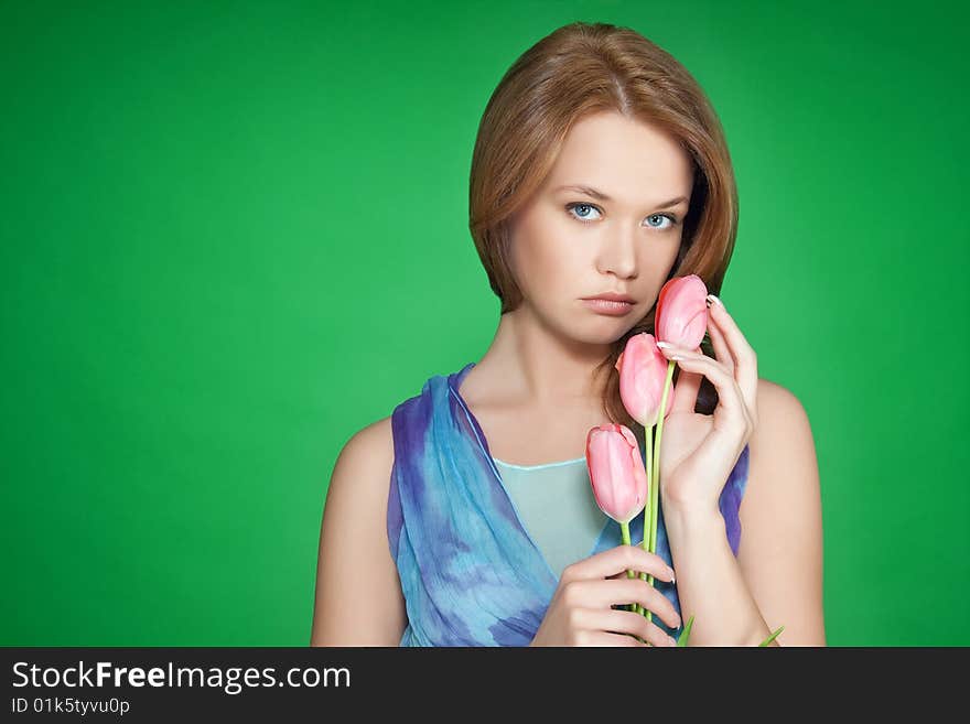 Beautiful girl with tulips over green