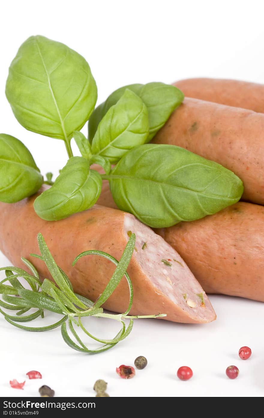 Detail of sausages with basil, rosemary and pepper