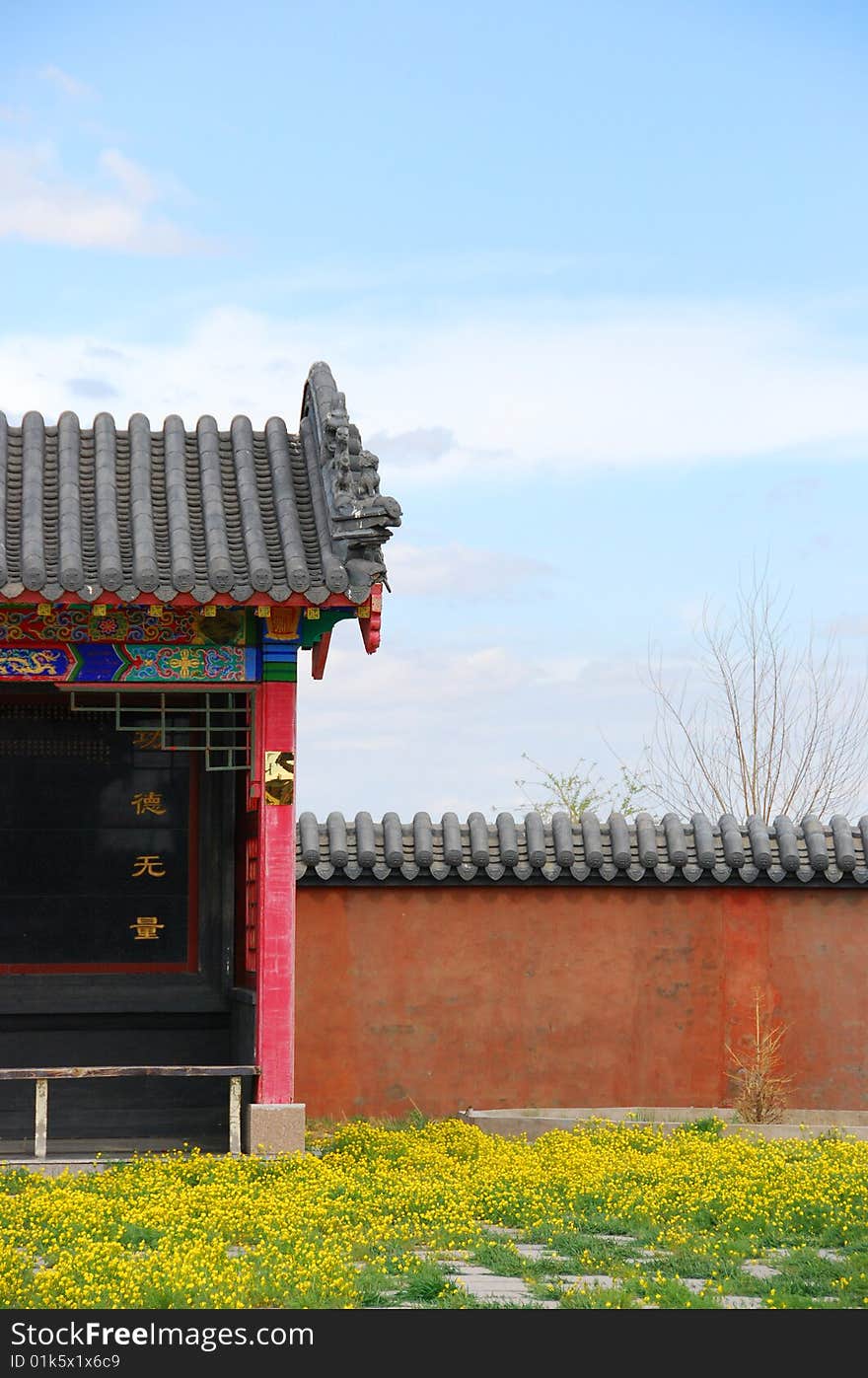 Temple with red wall and yellow flower. Temple with red wall and yellow flower