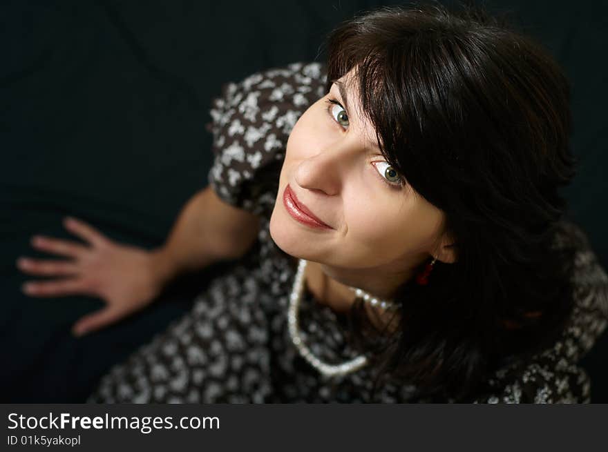 Portrait of young woman on black background