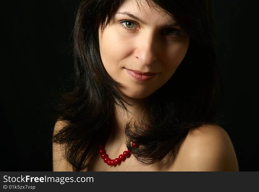 Portrait of young woman on black background