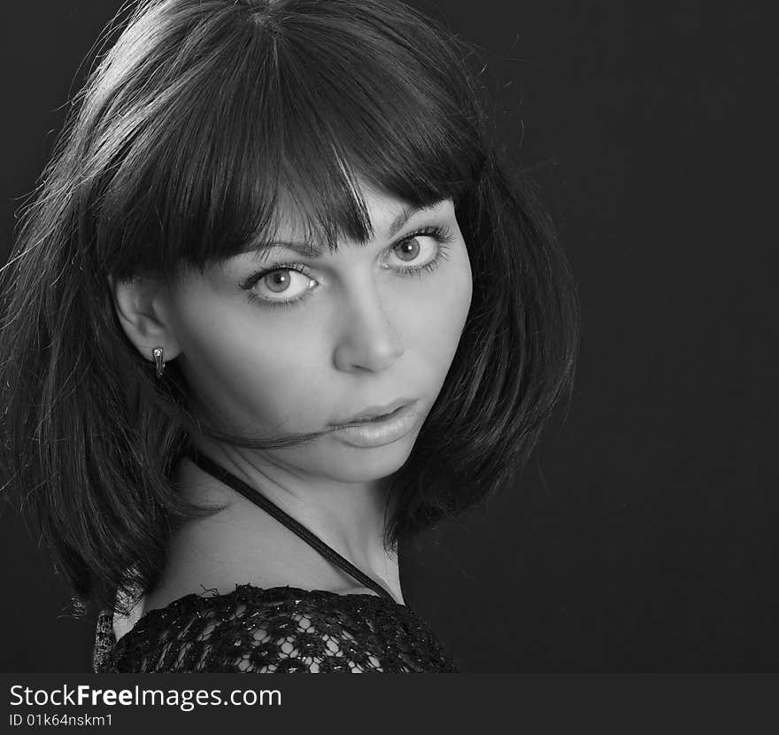 Young beautiful woman on black background