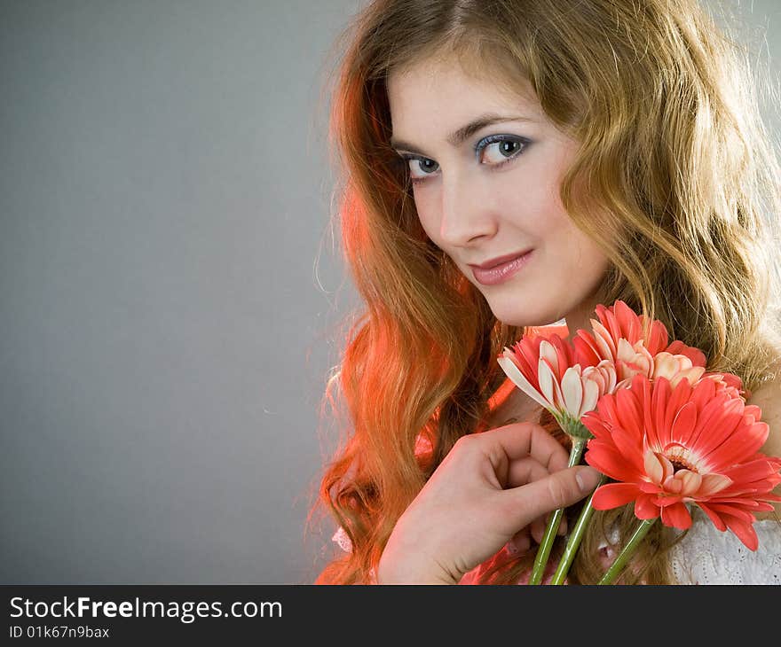 Beautiful young girl with red flowers. Beautiful young girl with red flowers