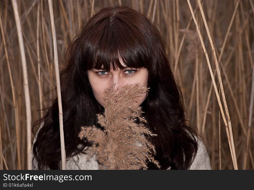 Girl look through the reed. Girl look through the reed