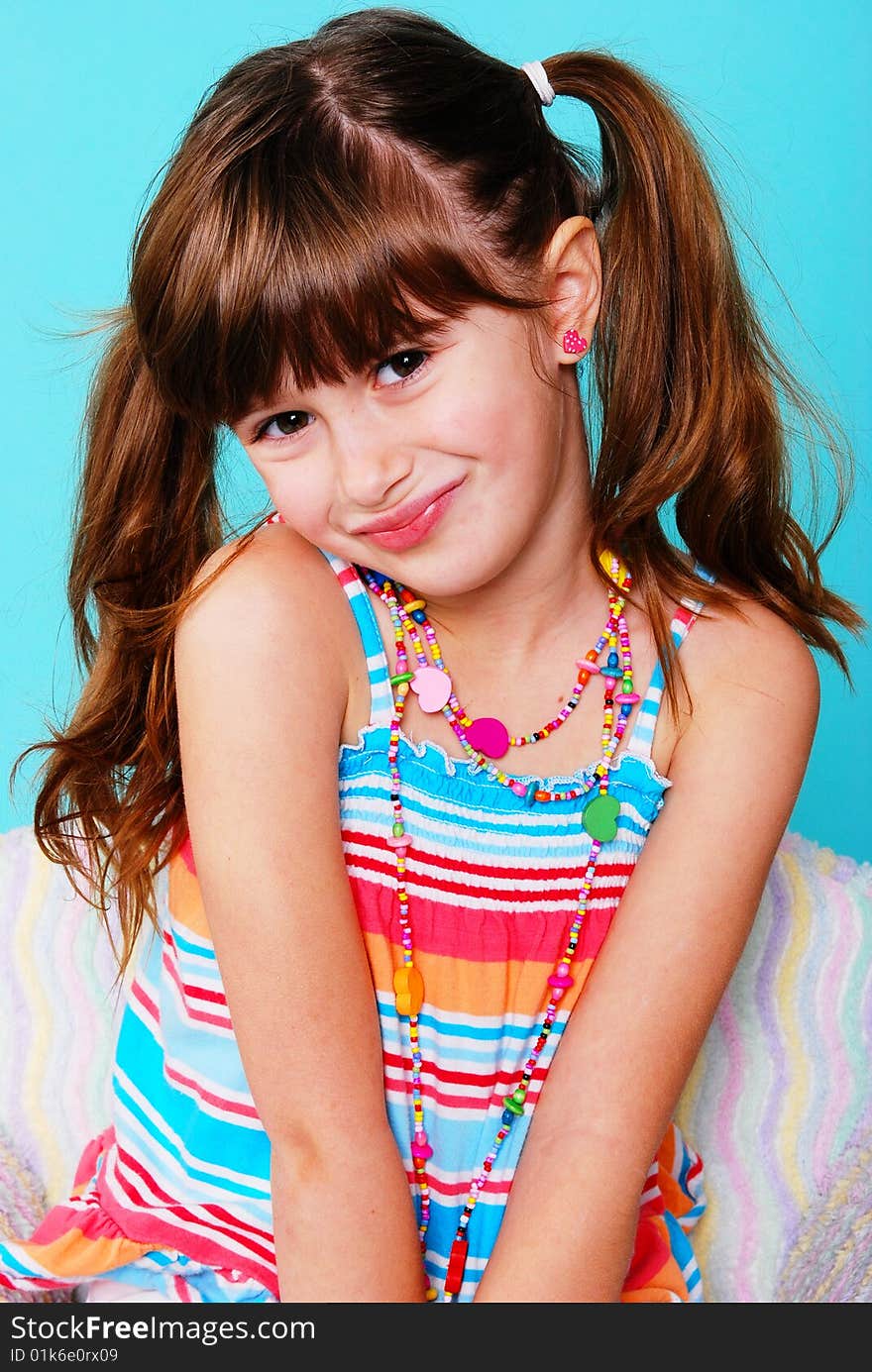 A cute young girl sitting in chair. A cute young girl sitting in chair