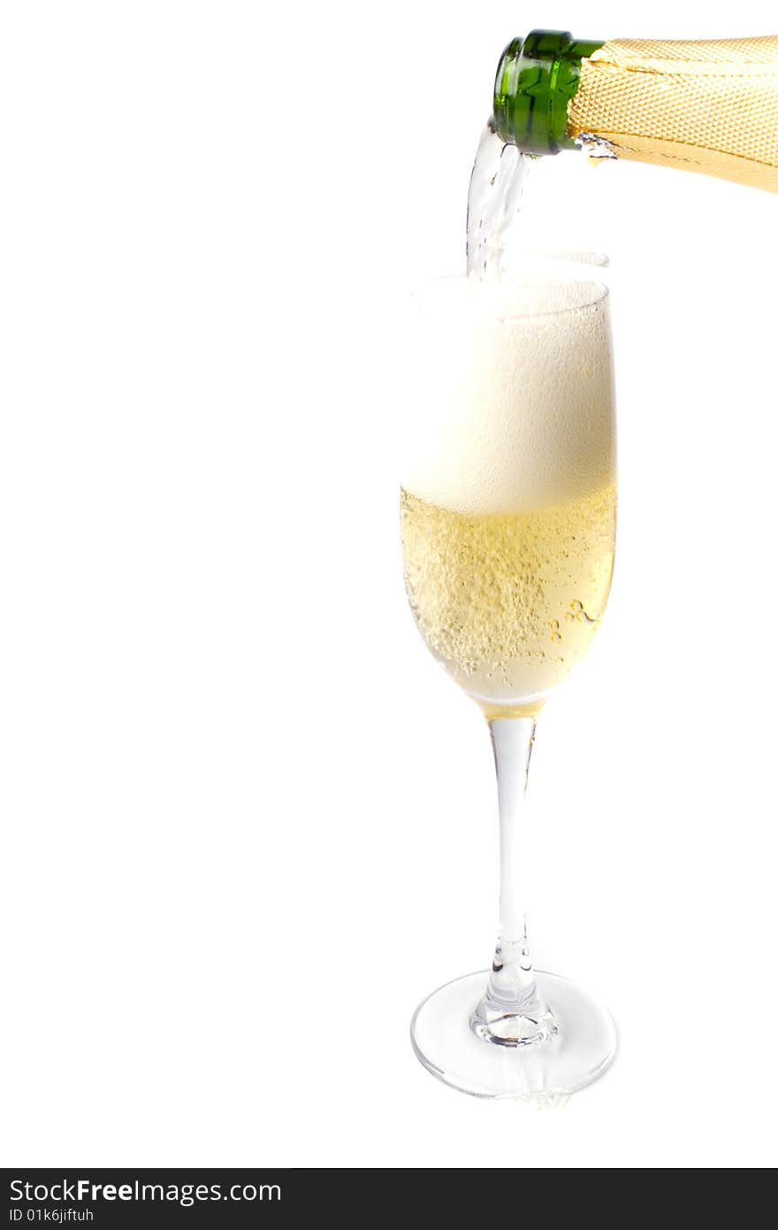 Champagne being poured into glass isolated on white background.