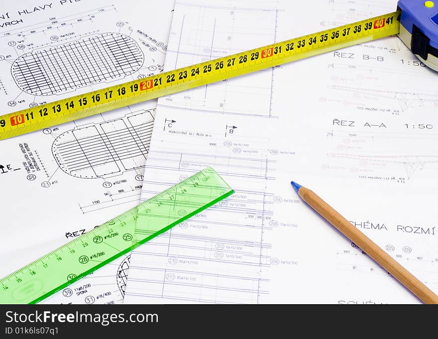 A technical design with a pencil and a measure tape