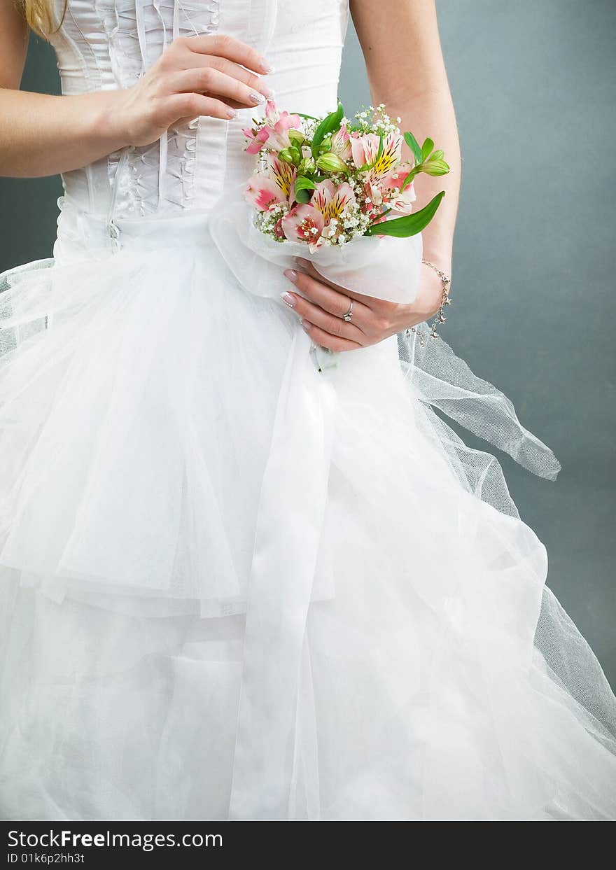 Elegant wedding bouquet at bride's hands