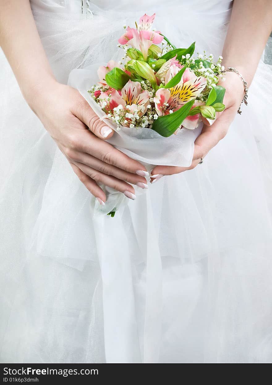 Elegant wedding bouquet at bride's hands