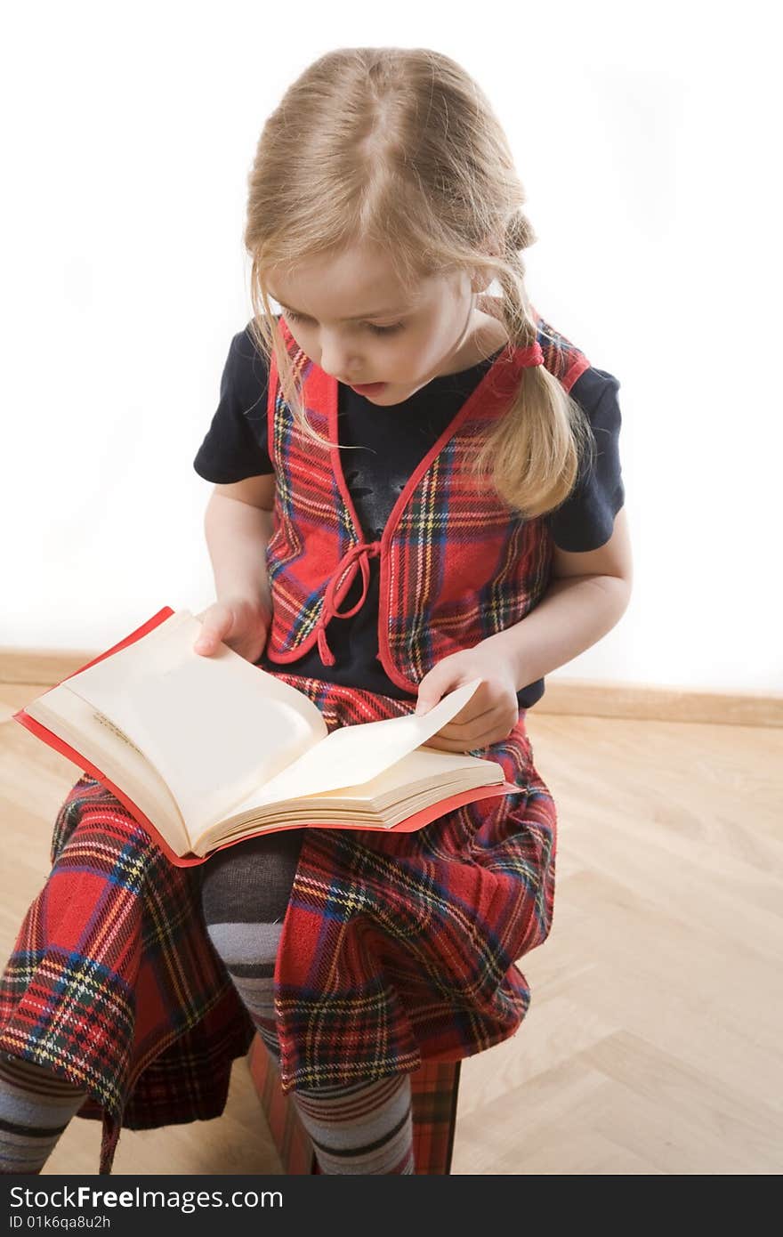 Serious schoolgirl with red book over white. Serious schoolgirl with red book over white