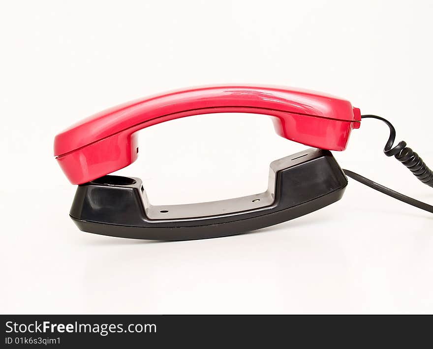 Red and black telephone isolated on white background